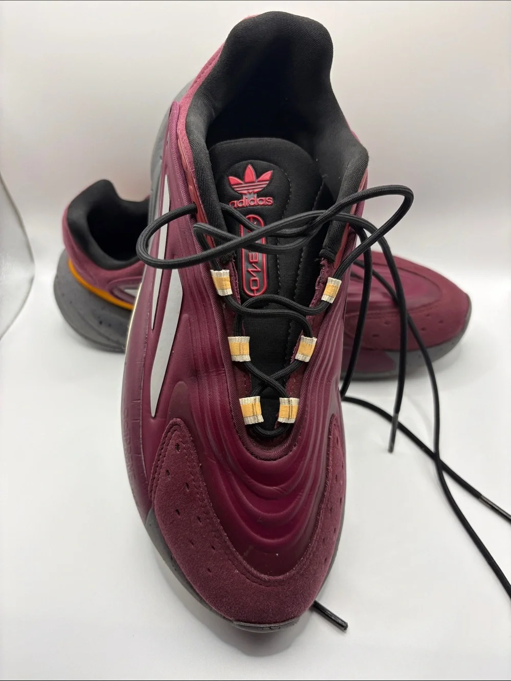 adidas OZELIA Men’s Burgundy and Black Running Sneaker with Yellow Accents